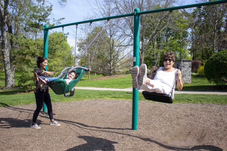 Grandma Maria Gomez, visiting from Chile, gets into the swing of things at Simcoe Park, with Claudia Castro and son Vicente, 3, on May 13. (Jessica Maxwell)