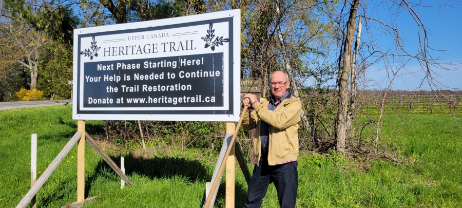 Rick Meloen, chair of the Upper Canada Heritage Trail, with a new sign at Concession 1 and East and West Line on May 7 announcing the next phase of the trail's development. It will run along Concession 1 from East-West Line to Line 3. (Tony Chisholm)