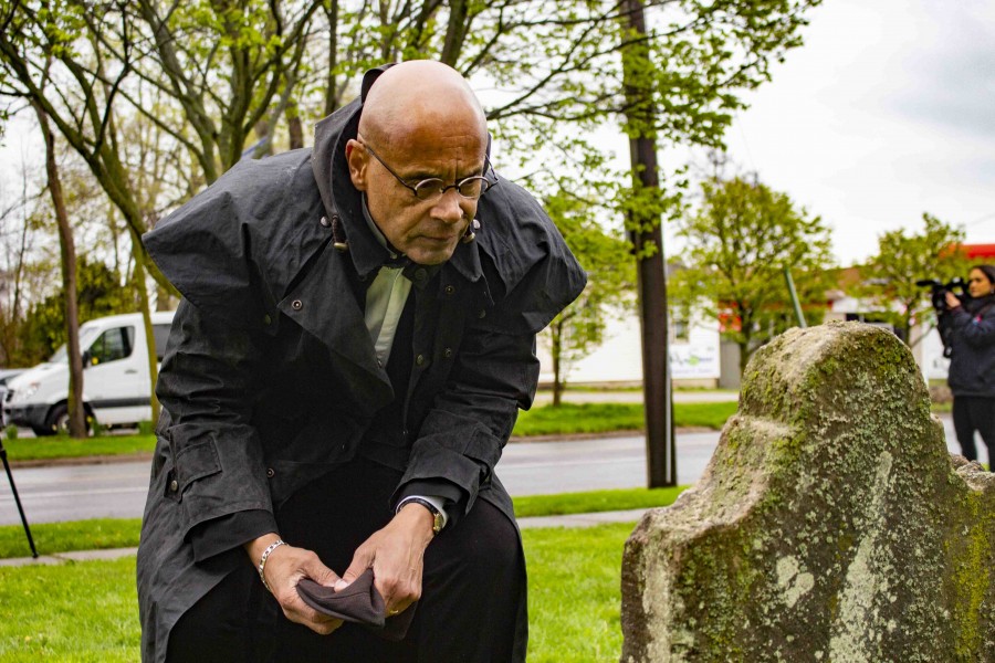 Jim Russell gazes at one of the three remaining headstones in the Burial Ground. (Evan Saunders)