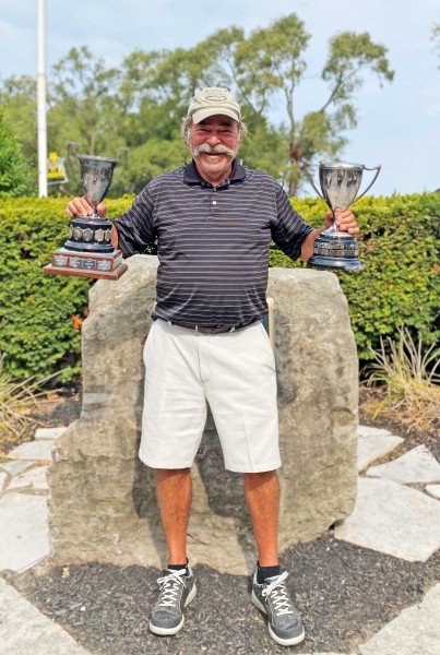 Jim McMacken has his hands full with the President's Cup and the Carmichael Cup. (Ricky Watson photo)