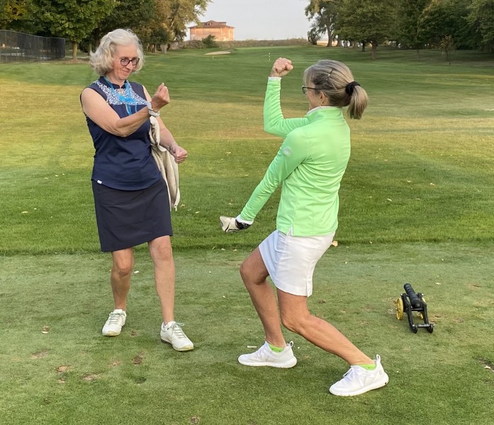 Team Blue captain Margot Richardson. left, and Team Green captain Maria Townley mix it up prior to their teams' match play .jpg competition. (May Chang photo)