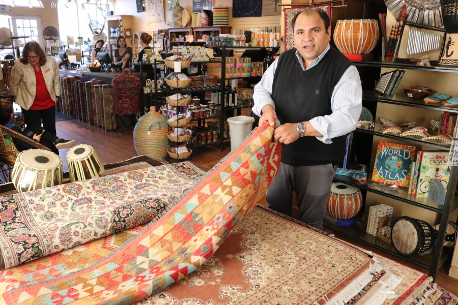 Yousaf Chaman, the director of fair trade company Bunyaad, shows one of the hand-knotted rugs.(Dariya Baiguzhiyeva/Niagara Now)