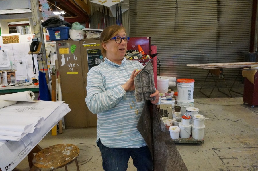 PIC: Scenic art head Gwyneth Stark explains the different treatments required for the brick surfaces of the set.