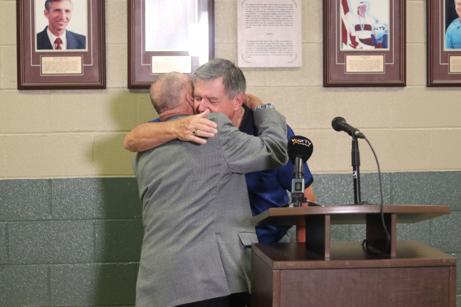 Doug Garrett hugs Ward Simpson, who is a Sports Wall of Fame committee chair. (Dariya Baiguzhiyeva)