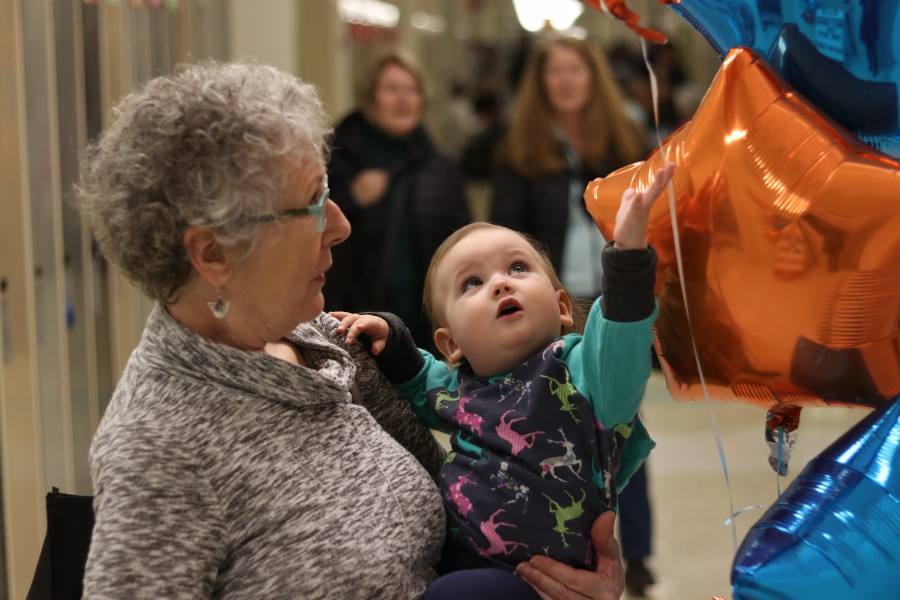 Pam Bennett watches as her 13-month-old granddaughter Elle Friesen plays with balloons. (Dariya Baiguzhiyeva/Niagara Now)