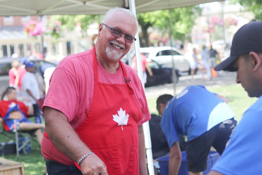 Joe Typer of St. Davids Lions' Club helping with the barbecue at Simcoe Park. (Dariya Baiguzhiyeva/Niagara Now)