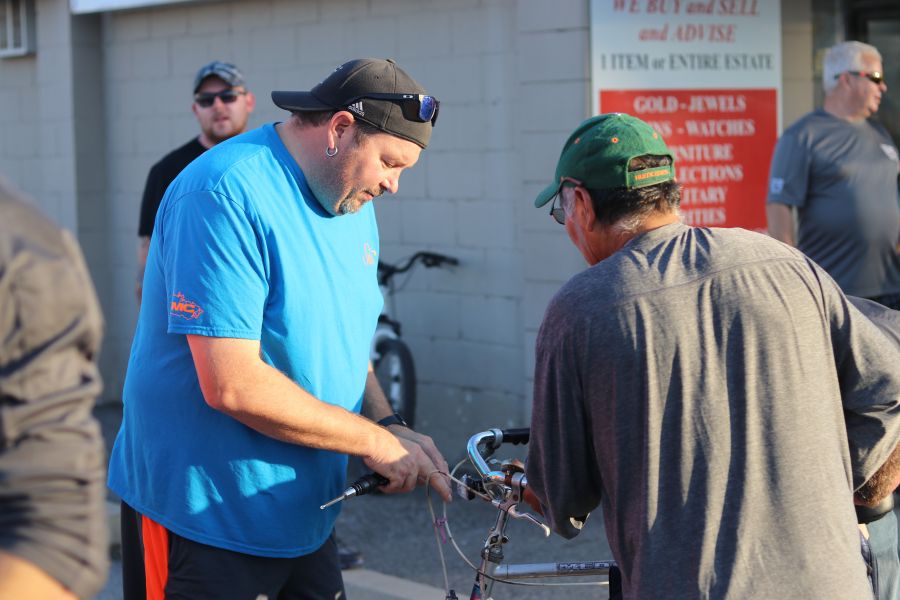 Trevor Legault of the Silks Raiders baseball team installs lights on the bike at the second Lights for Bikes event last Thursday. (Dariya Baiguzhiyeva/Niagara Now)