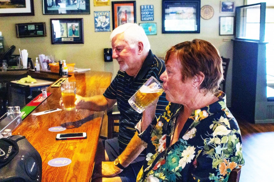Paul and Suzanne Doran enjoy an afternoon pint at Sandtrap Pub & Grill Wednesday afternoon. Suzanne said she definitely feels safer knowing only double-vaccinated patrons are allowed inside the restaurant. (Evan Saunders)