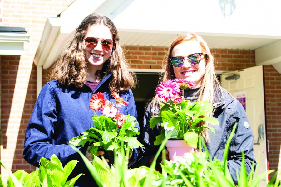 Mattison Innis and Leslie Hockley, first-year Niagara Parks School of Horticulture students, at the St. Mark spring garden sale Saturday. (Richard Harley/Niagara Now)