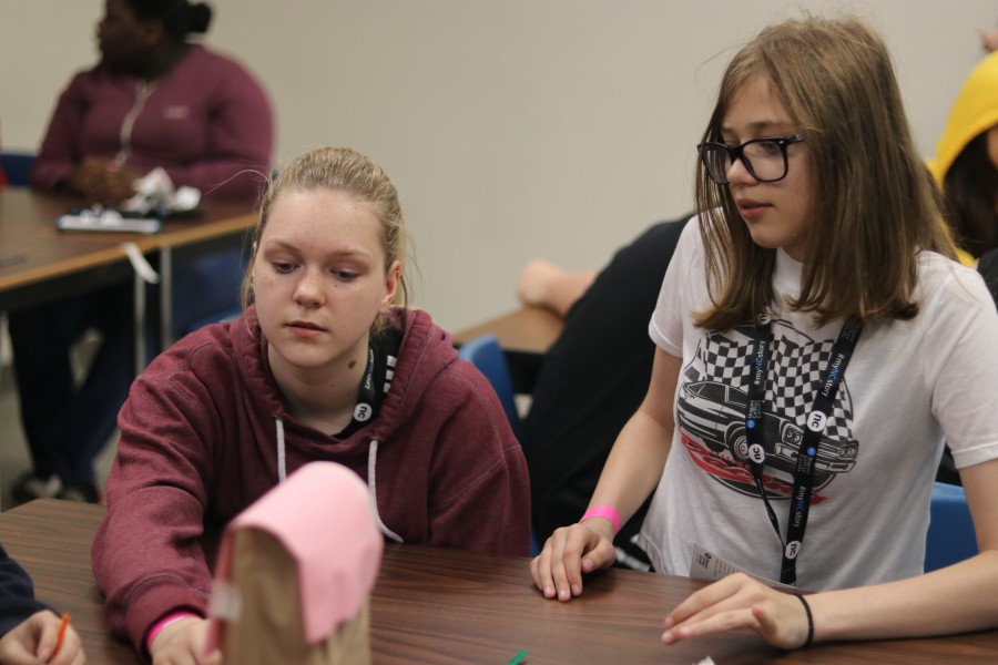 At the business workshop, Isabella Kolbuc, left, and Haylie Gracie work on making a backpack at the business and marketing workshop. (Dariya Baiguzhiyeva/Niagara Now)