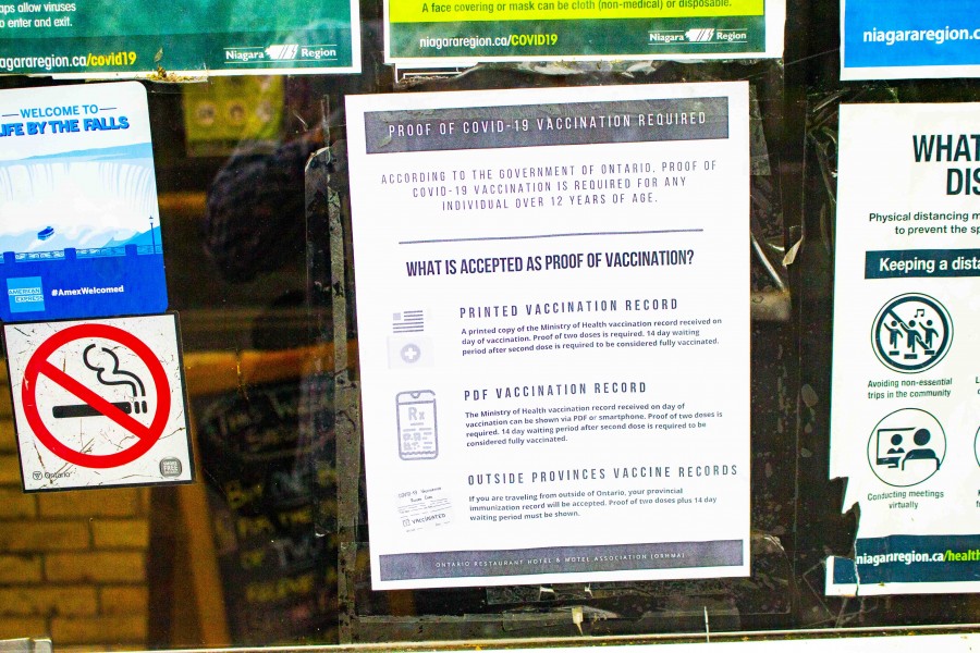 Vaccine certificate notices such as this adorned the window sills of many restaurants around NOTL on Wednesday. (Evan Saunders)