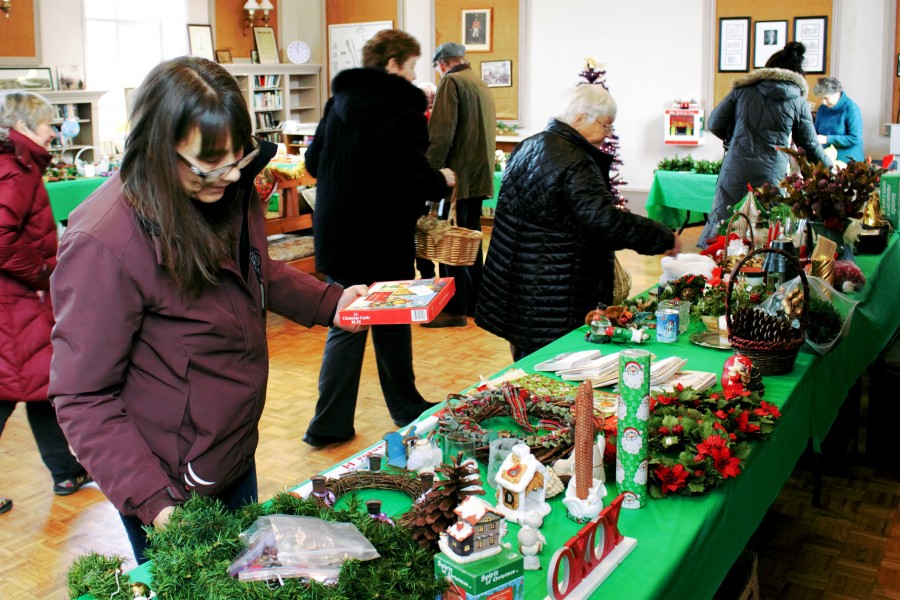 Yvonne Newton browses the Queenston Annual Christmas Bake and Decor Sale on Saturday. (Brittany Carter/Niagara Now)