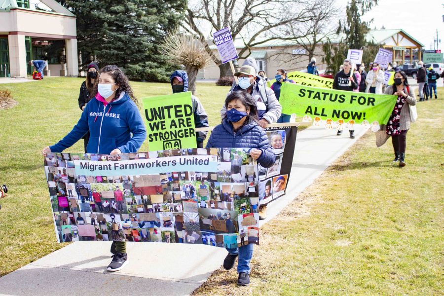 Advocates, residents and migrants workers march in front of NOTL's town hall to stand up against racism and call for permanent residency for all migrant workers. (Evan Saunders)