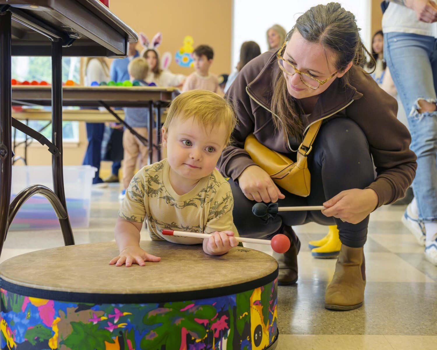 Brooks, 18 months old, plays drums with mom Kristen Wall during the Bunny Trail event held by Niagara Nursery School.