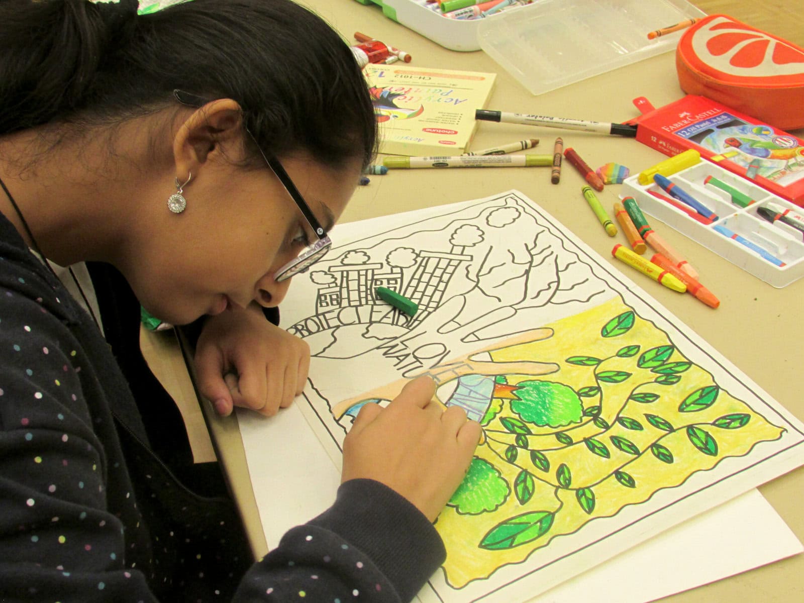 13-year-old Kuhu creates a drawing inspired by her passion for environmental awareness. The drawing reads, "Protect Earth" and "Love nature." 