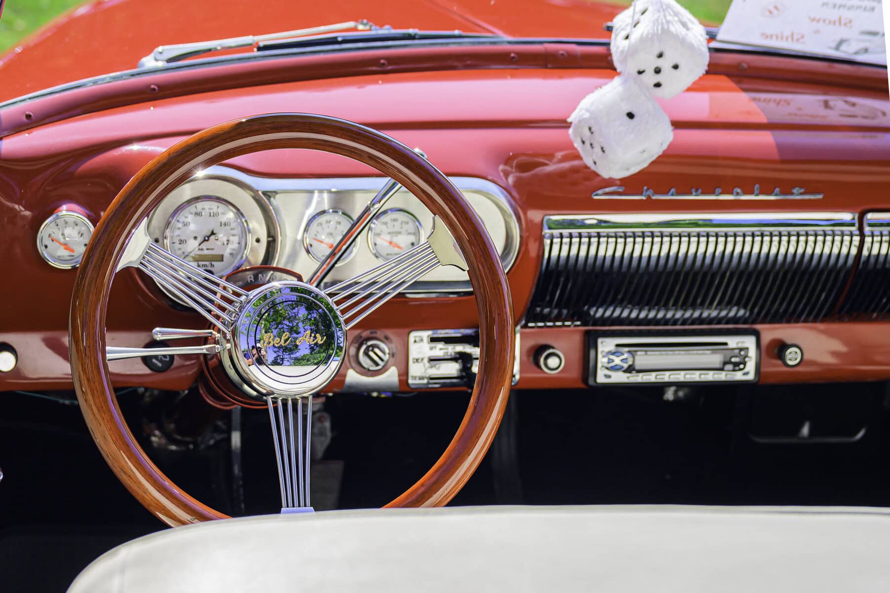 The shiny interior of this 1954 Chevrolet Bel Air convertible — dice in mirror included.