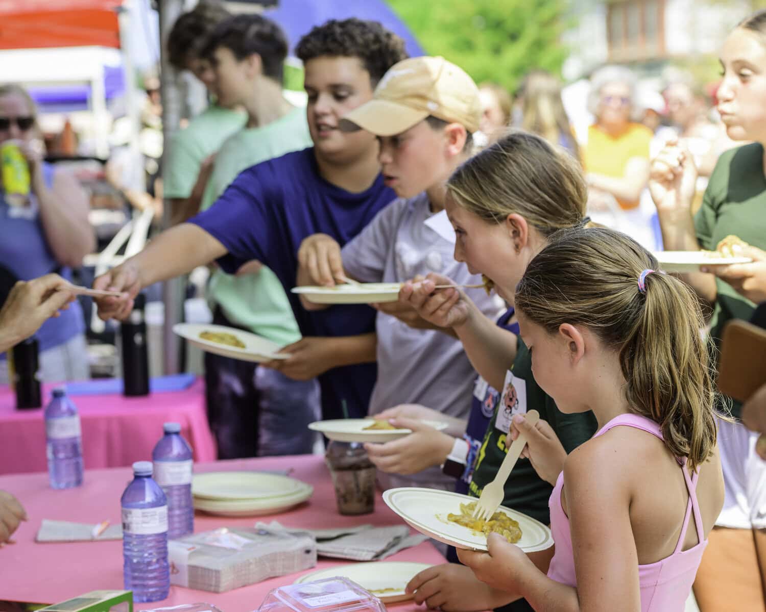 After the peach pie contest is over, these young festivalgoers get to enjoy the leftovers, each receiving a slice.
