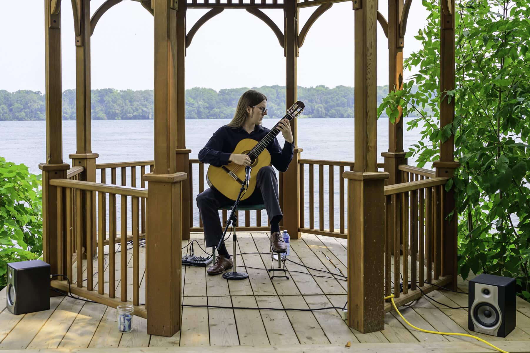 A scenic view at the Pumphouse's gazebo, Adrian Papex provides the soundtrack for the art gazebo with a bit of guitar music.
