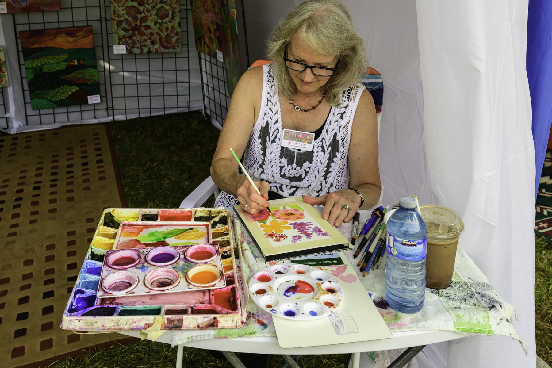 Susan Little demonstrates her skill with watercolours, creating a vibrant painting of a variety of flowers.
