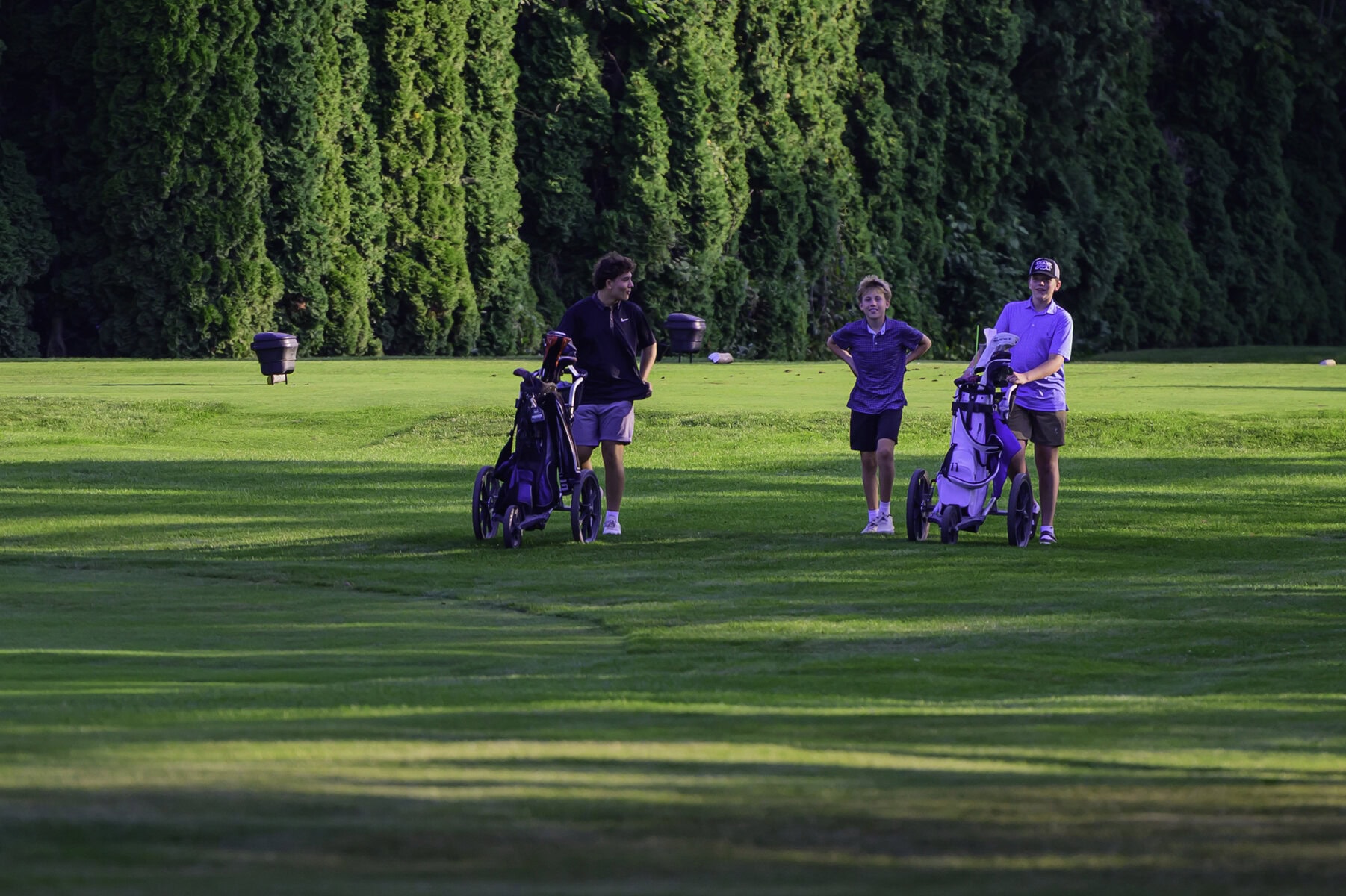 Bantam boys Gabe Santelli and Steven Pillitteri-Smith, with his caddy, walk the ninth fairway. 