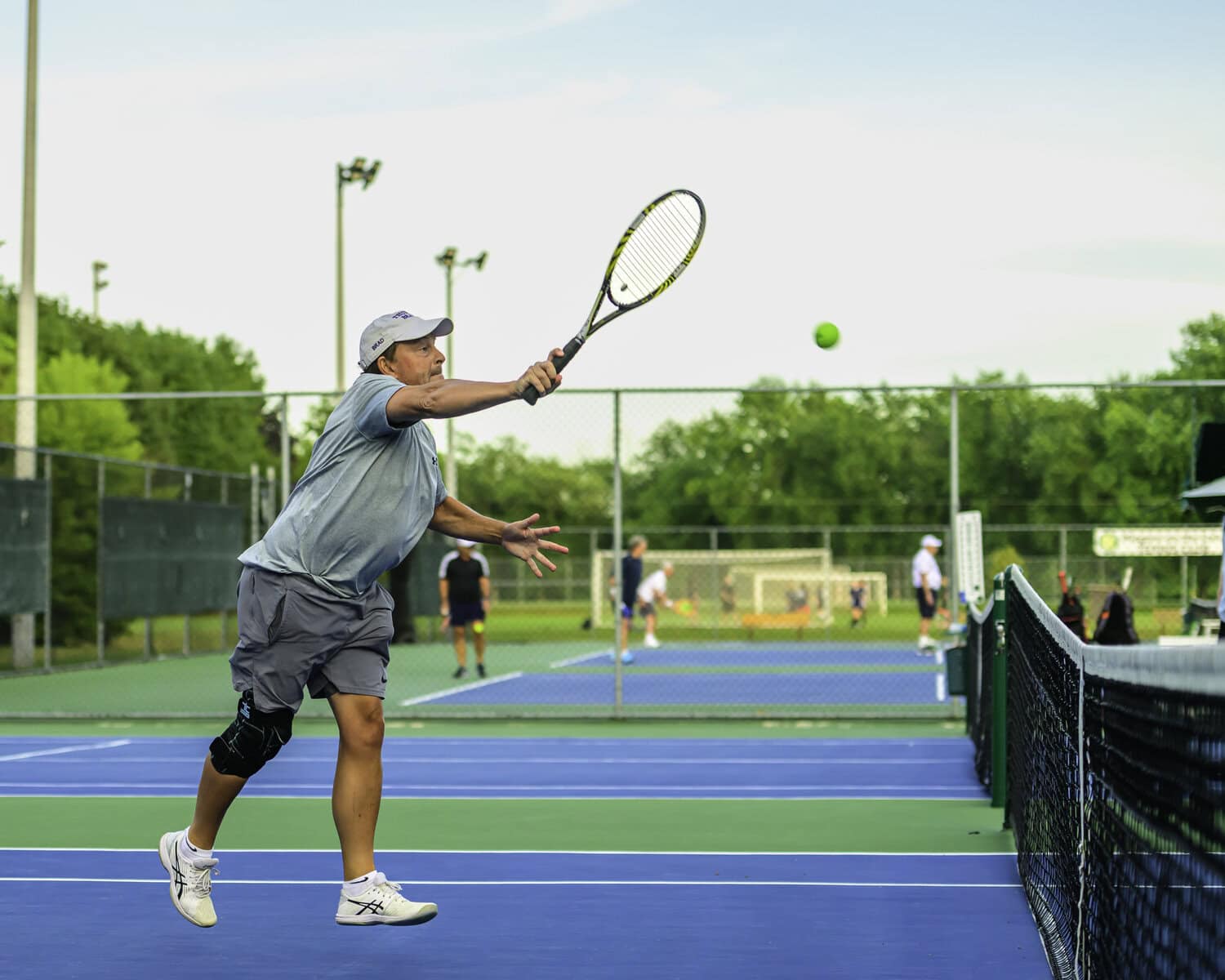 Brad Butler, who played with Rob Lipovsky, returns a volley to the team of Jonathon Dick and Gerry Pepe.