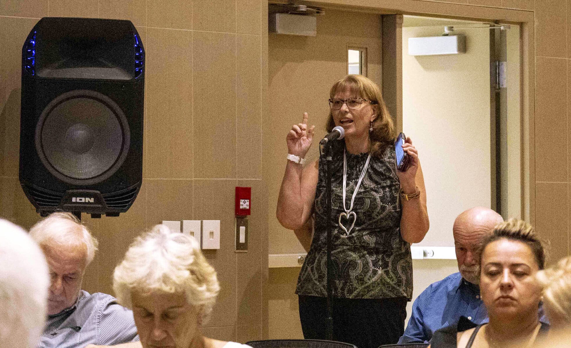Julia Buxton-Cox asks a question during the Wellness Estates information session, raising concerns about council engagement and delivery on past promises.