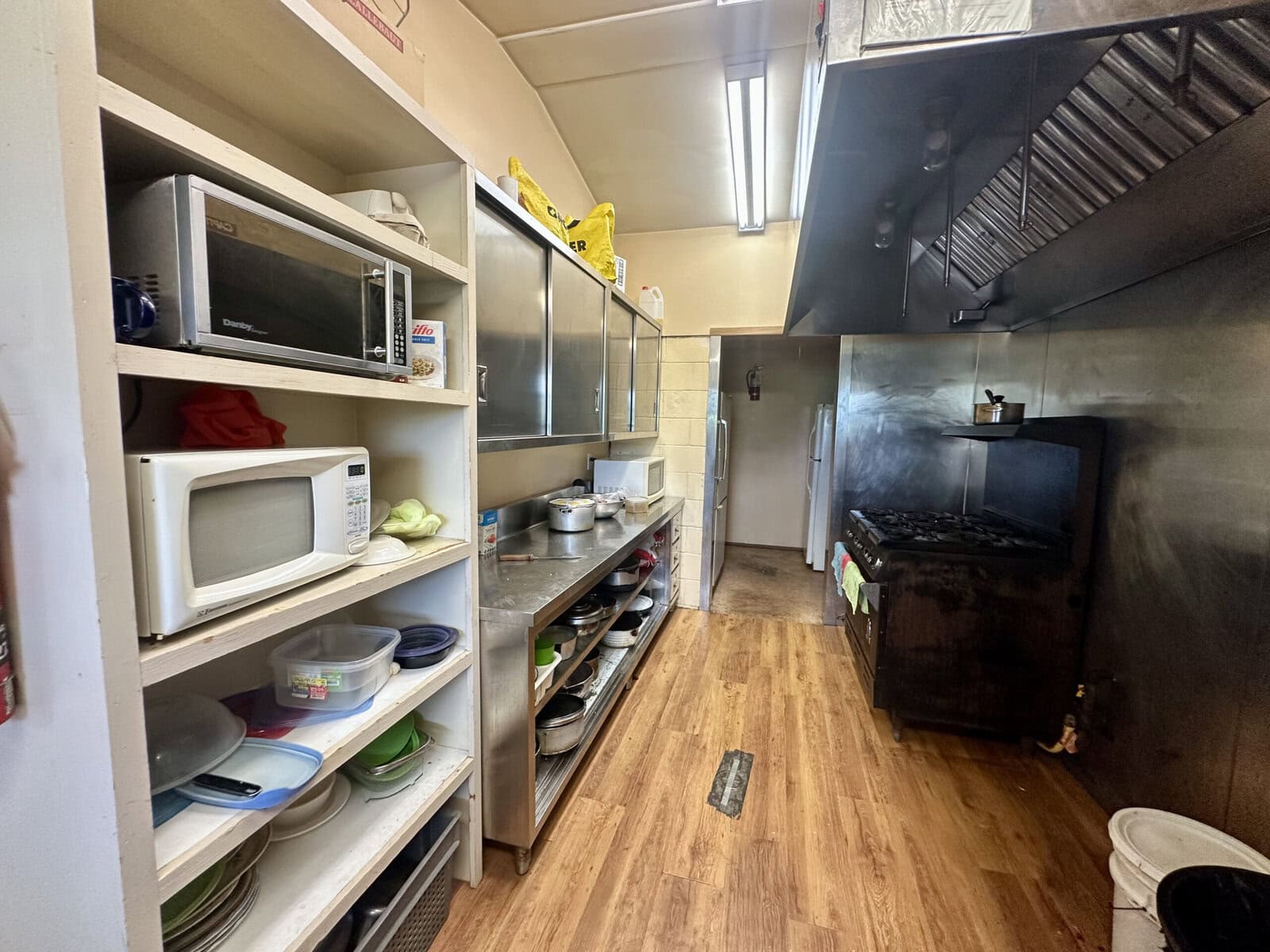 Clean, commercial-style kitchen used by migrant workers at Glenlake Orchards and Vineyards, where owner Kevin Buis says housing meets inspection standards and some workers have returned for decades.