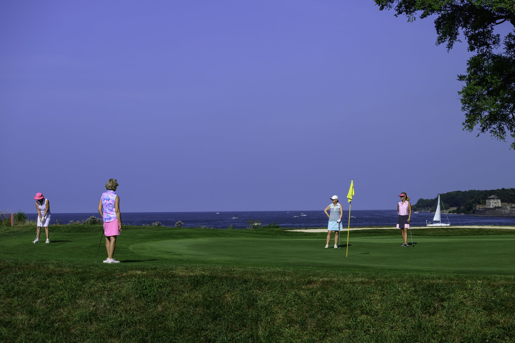 Carroll Baker putts on the 10th green, with Martha Cruikshank, Yolanda Henry and Louise Robitaille watching.