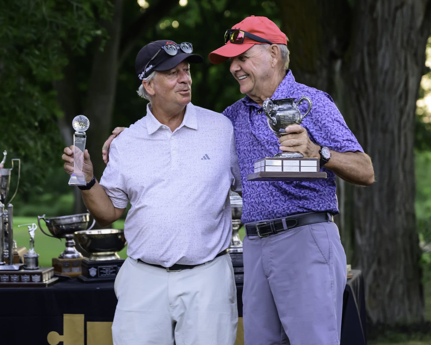 Jim Garrett, left, took the men's C flight and called up playing partner Brian Herr, right, to help him celebrate.
