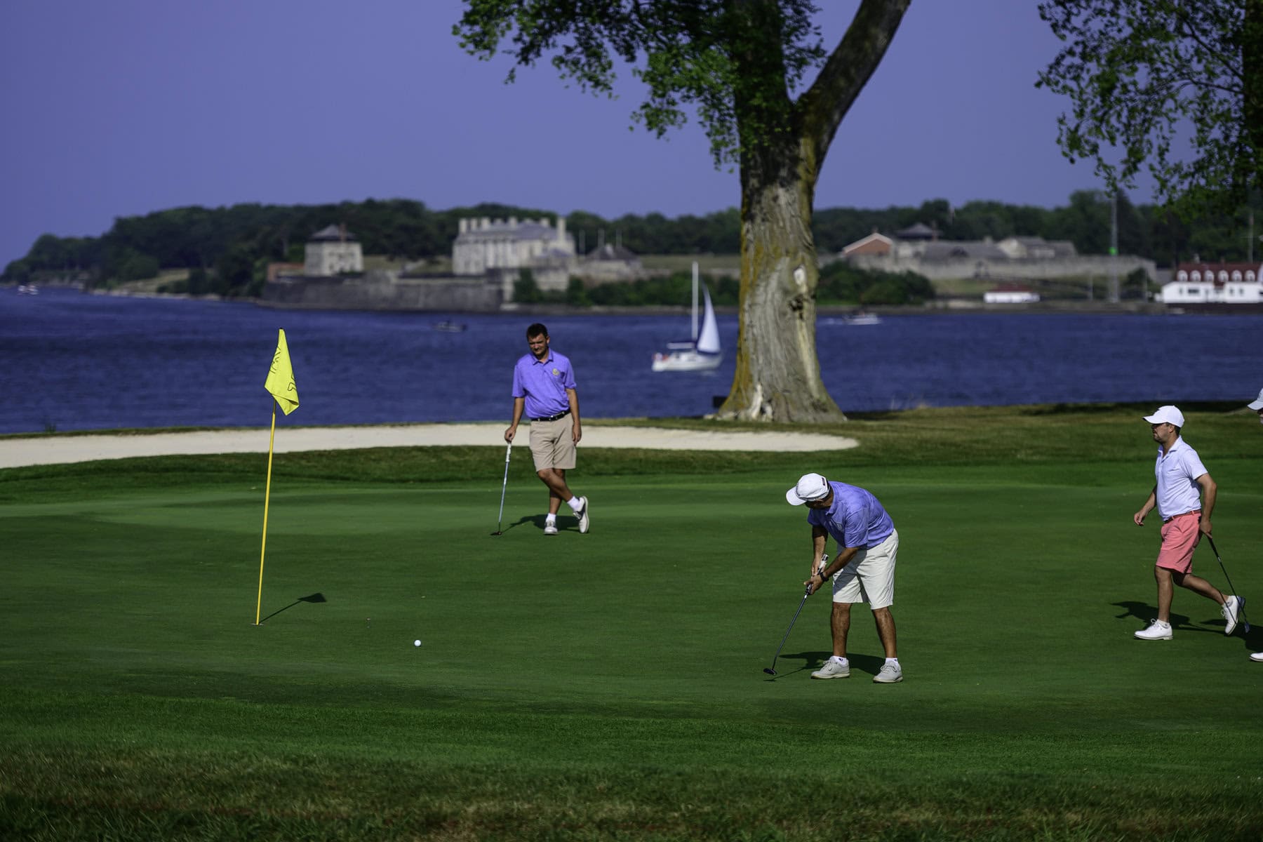 James Grigjanis-Meusel and Ricky Watson watch as Joe Doria putts on #1.