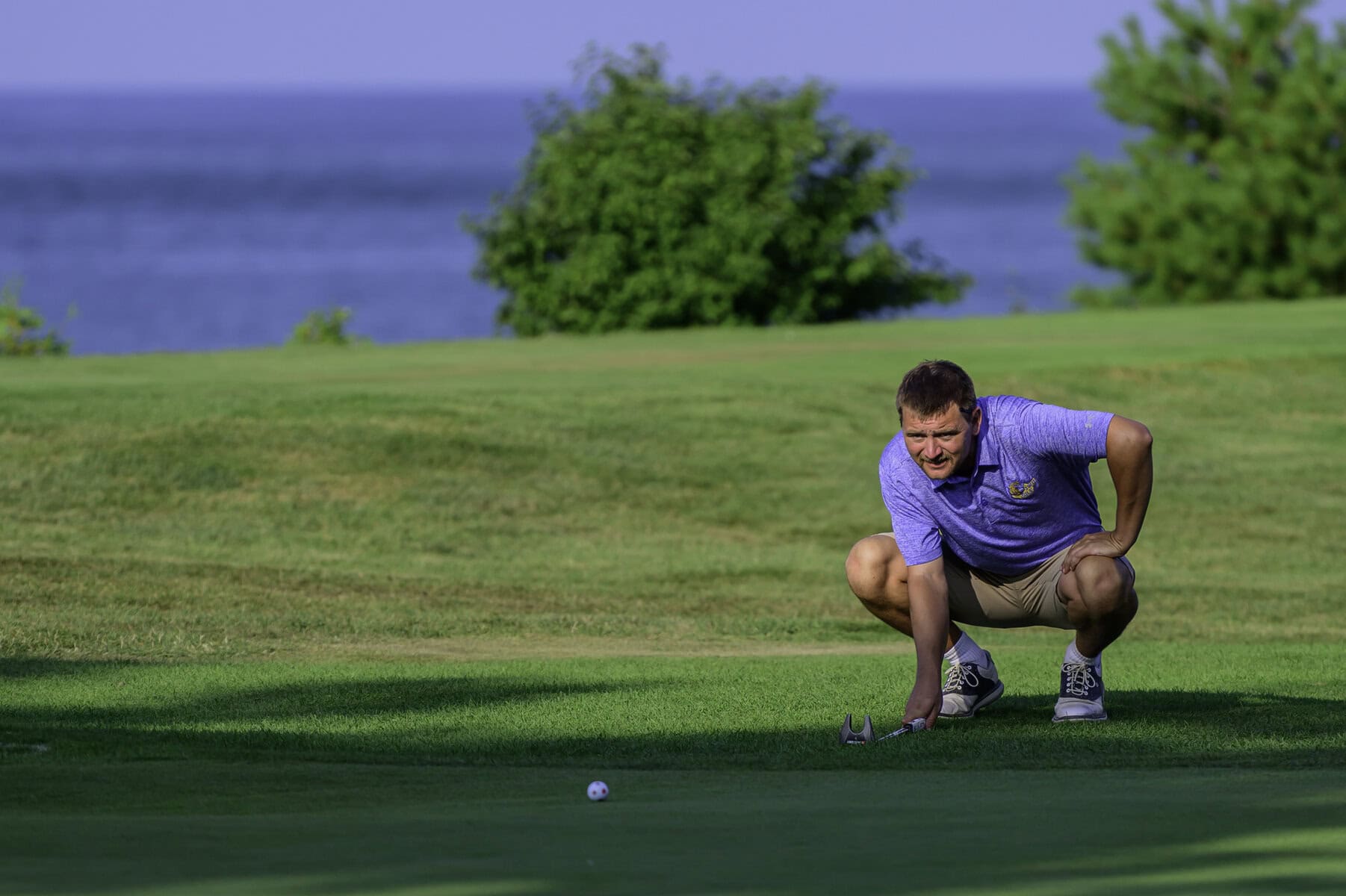 James Grigjanis-Meusel goes low to eyeball his putt. 
