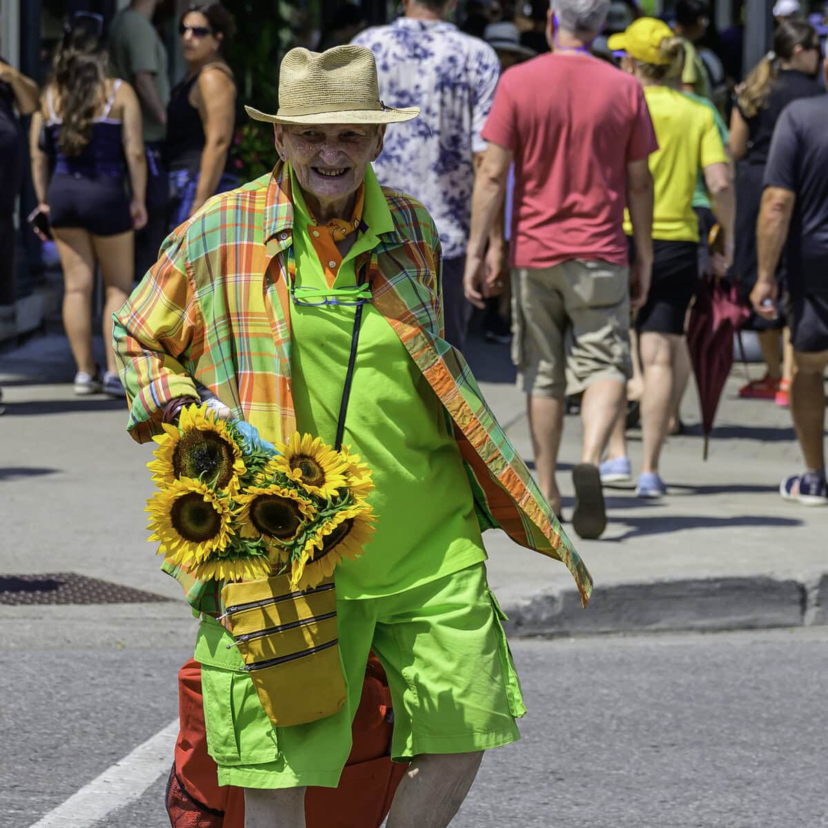 M.J. McGraw spreads a little sunshine on Queen Street, handing out sunflowers purchased at NEOB Lavender.