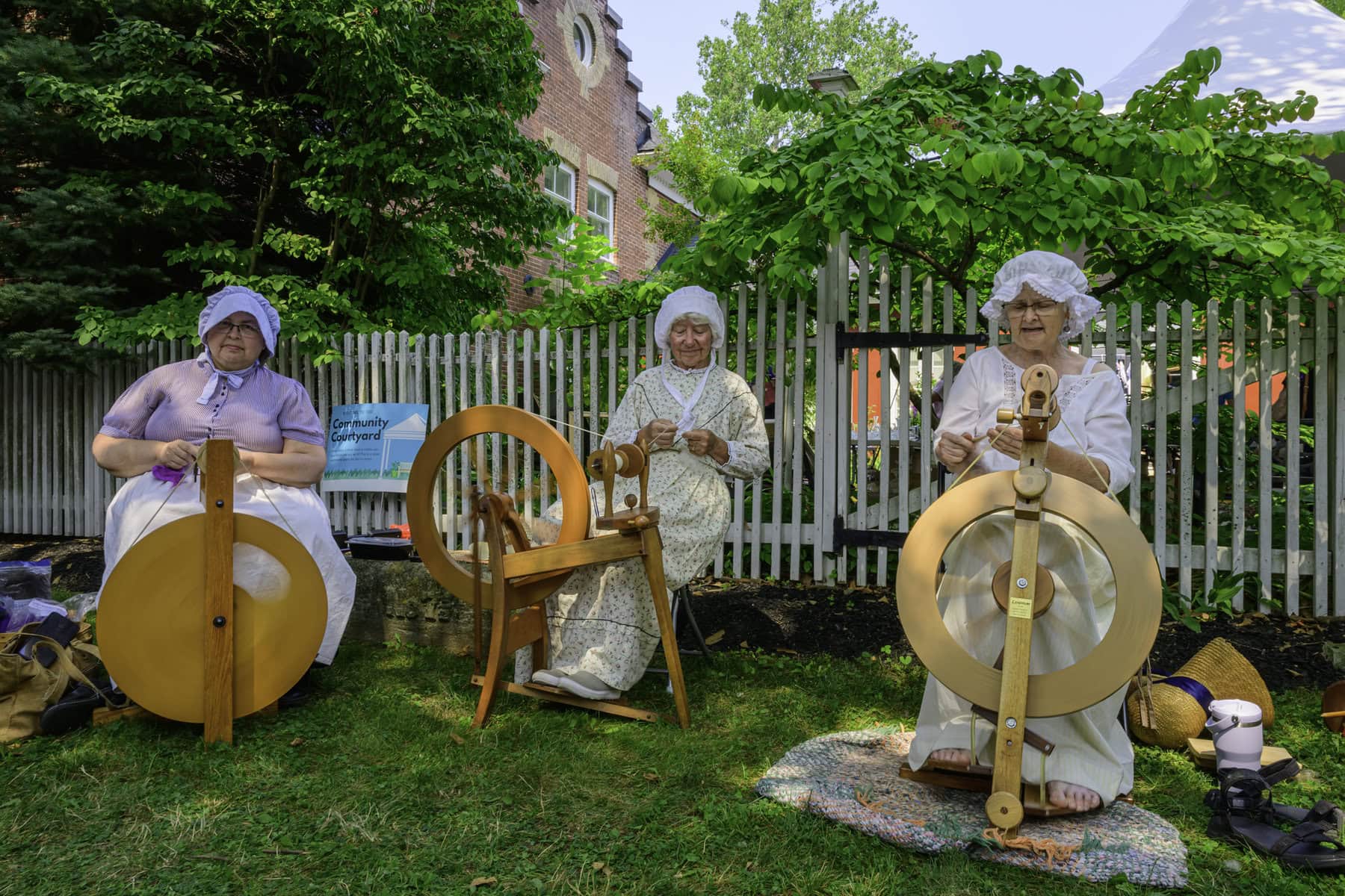 Elaine Anderson, Fran Giles and Anna Chandler of Niagara Hand Weaver and Spinner demonstrate the thousands-year-old art of spinning wool into yarn.