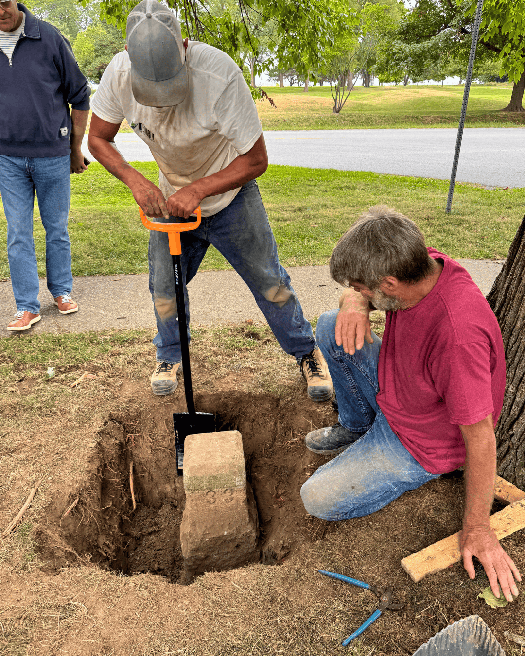 Crews carry out restoration on a boundary stone.