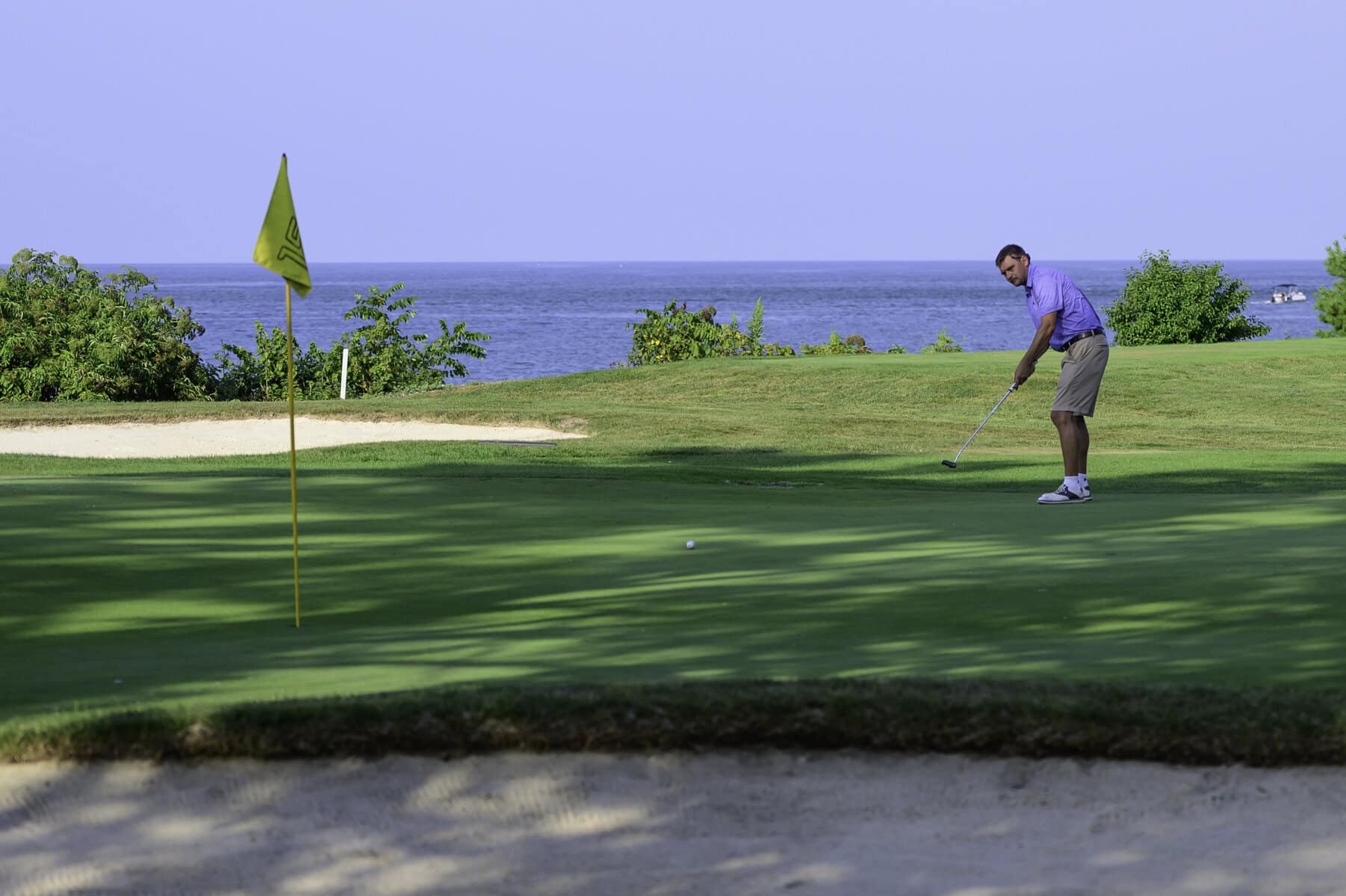 On the sixth green, James Grigijanis-Meusel rolls a putt toward the hole. 