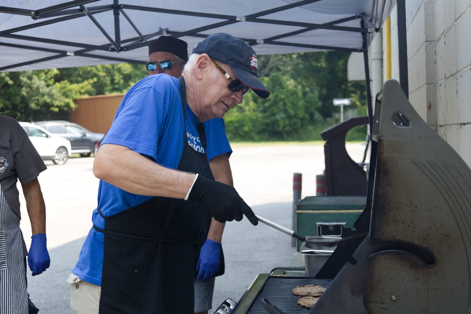 Rhys Beak grills up some burgers for the civic holiday celebration outside the Legion this past weekend.