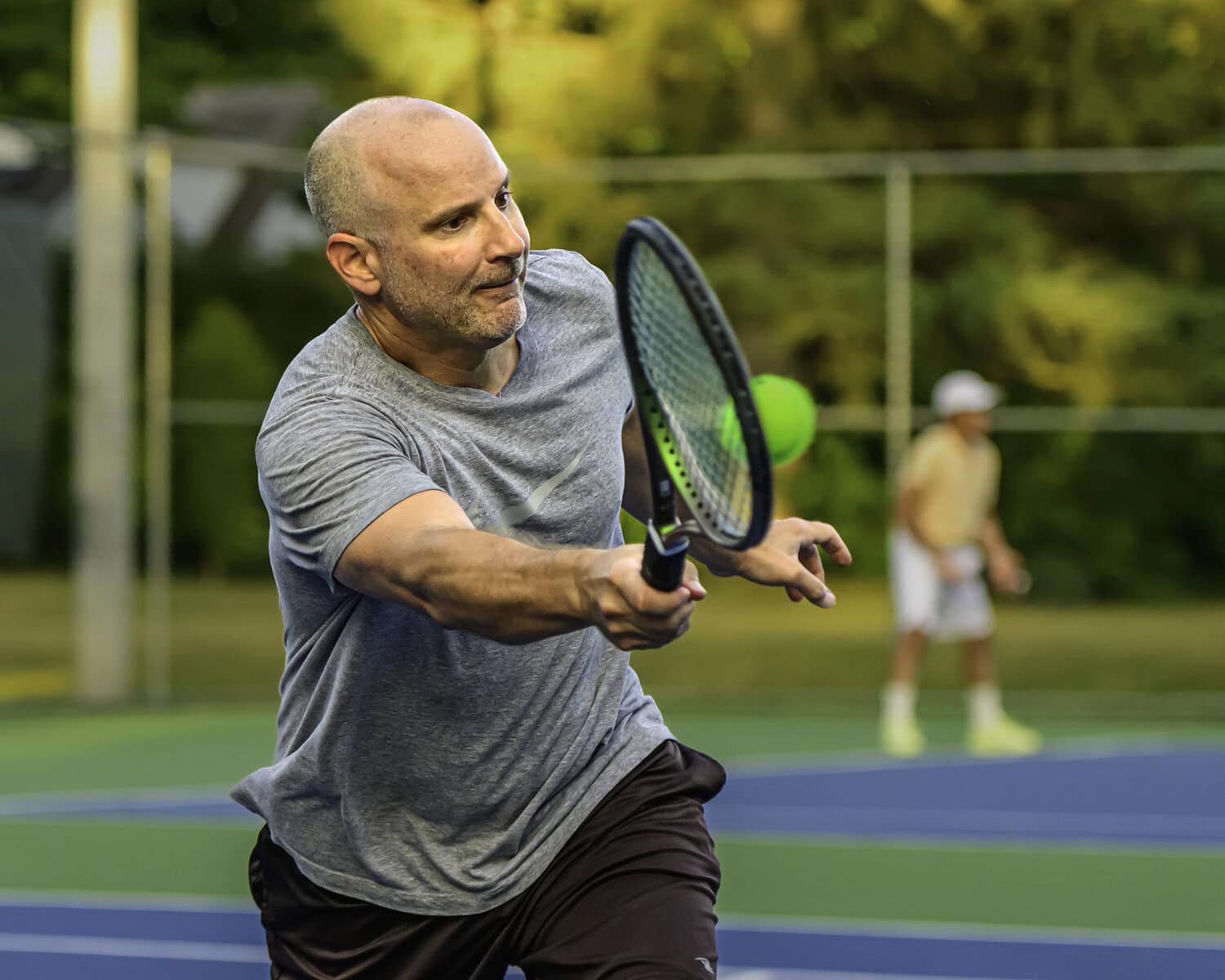 Rob Lipovsky returns a volley to the team of Jonathon Dick and Gerry Pepe.