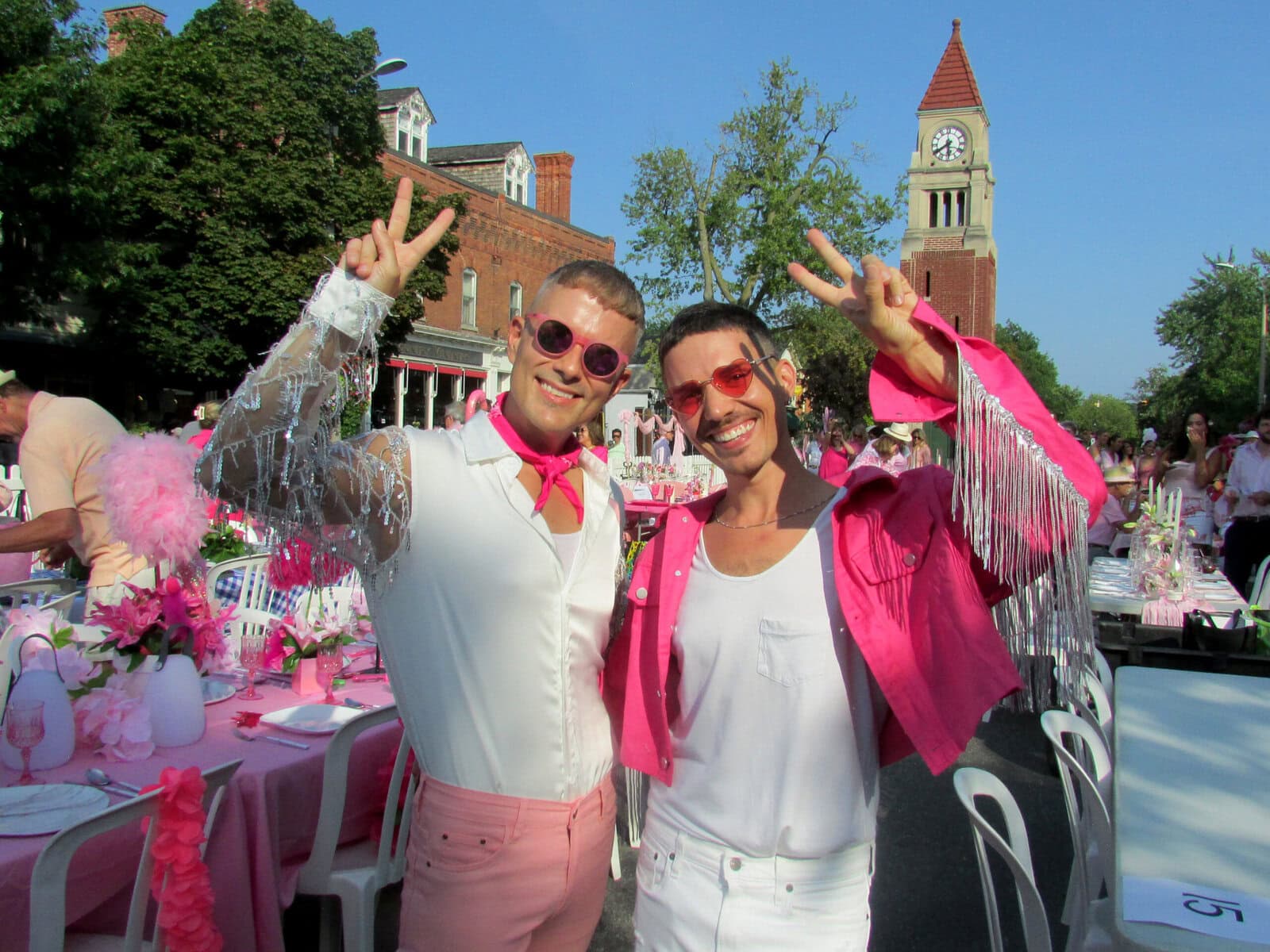 Mike Matyjewicz and Jeff Graham hold up peace signs at the NOTL Chamber of Commerce Shades of Summer event. The picnic-style event included an outside dinner and music on Queen Street. 