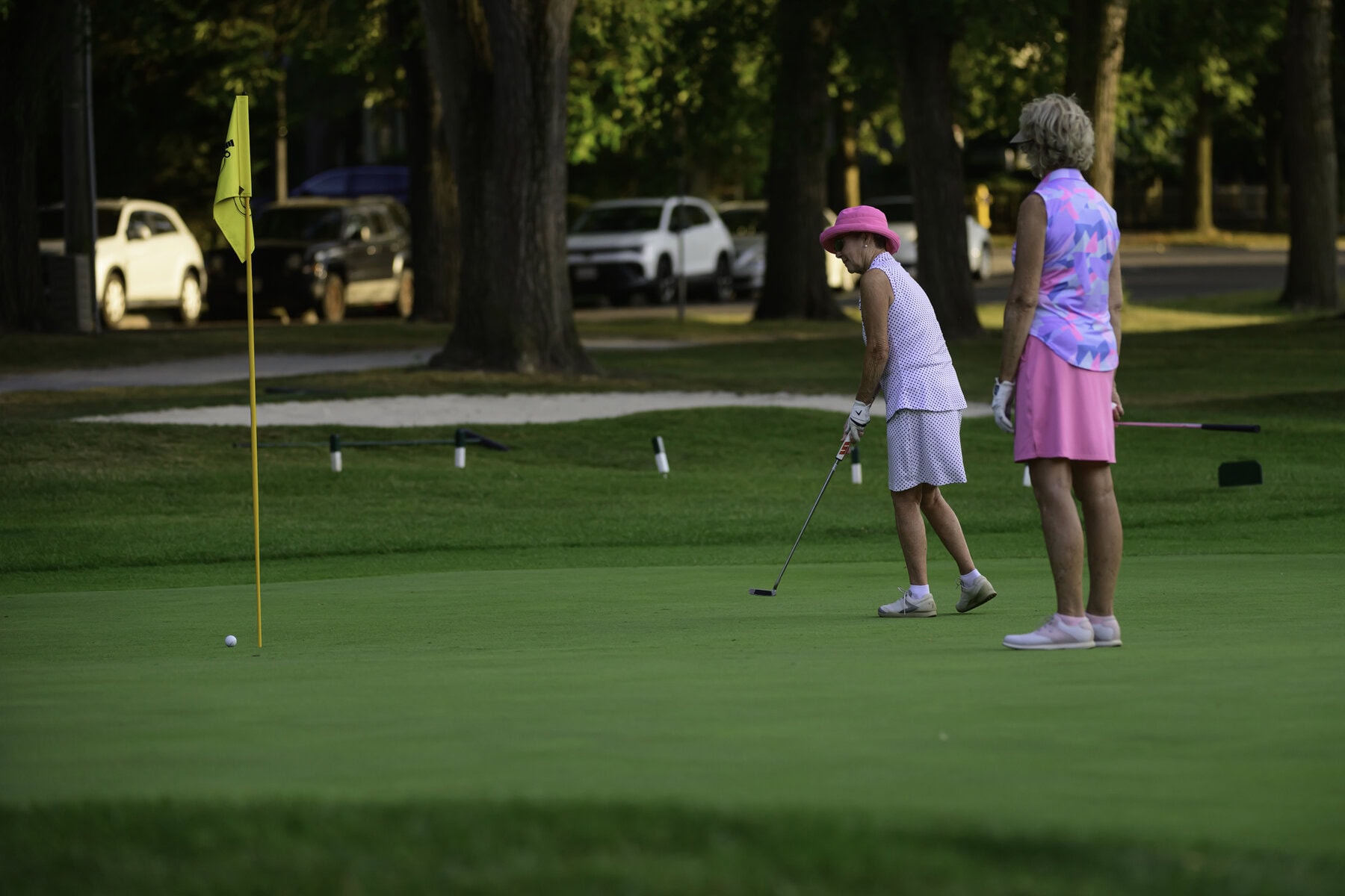 Women's seniors champ Carroll Baker narrowly misses a putt on #18. Martha Cruikshank looks on.