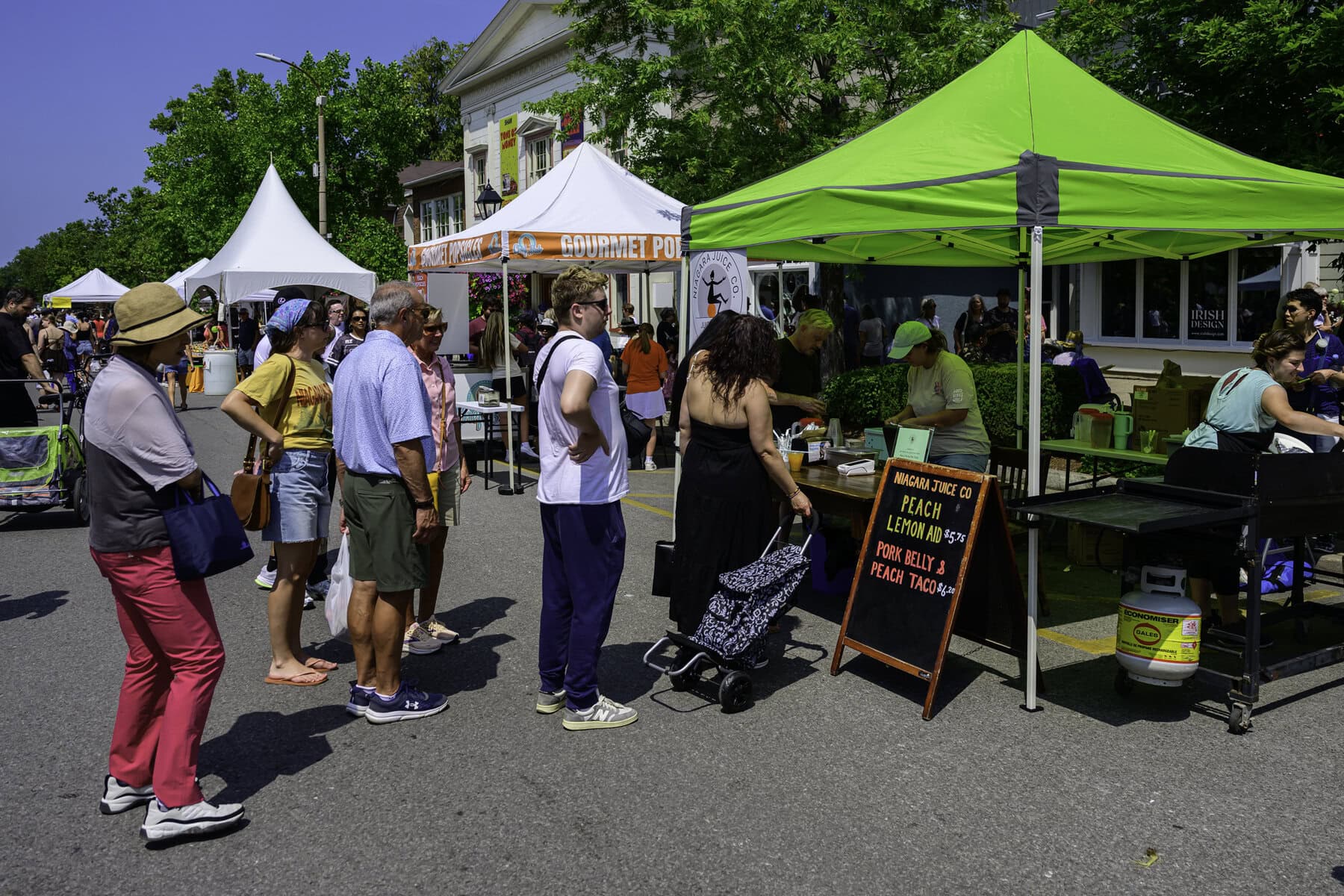 With the temperature at a blistering high of 33 C on Saturday, festivalgoers line up to cool off with some peach lemonade.