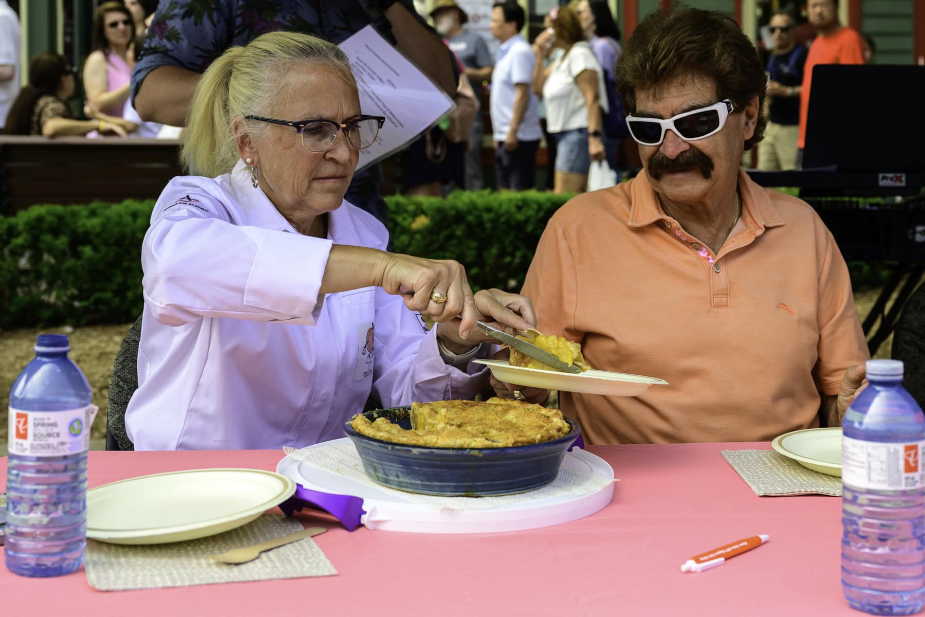 Over at the peach pie contest on the weekend, chef and judge Catherine O'Donnell cuts one of the other judges, MPP Wayne Gates, a healthy slice of peach pie to taste.
