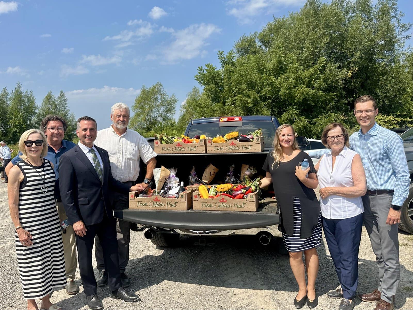 From left, Niagara-on-the-Lake Coun. Wendy Cheropita, NOTL Lord Mayor Gary Zalepa, minister of agriculture Trevor Jones, NOTL Deputy Lord Mayor Erwin Wiens, minister of infrastructure Kinga Surma, Town of Lincoln mayor Sandra Easton and Conservative MPP Sam Oosterhoff stand with crates of fresh Niagara produce prepared by Erwin Wiens’ wife, Dorothy Soo-Wiens, for guests to take home after Monday’s irrigation funding announcement in St. Davids. “Without water, none of this happens,” Erwin said.
