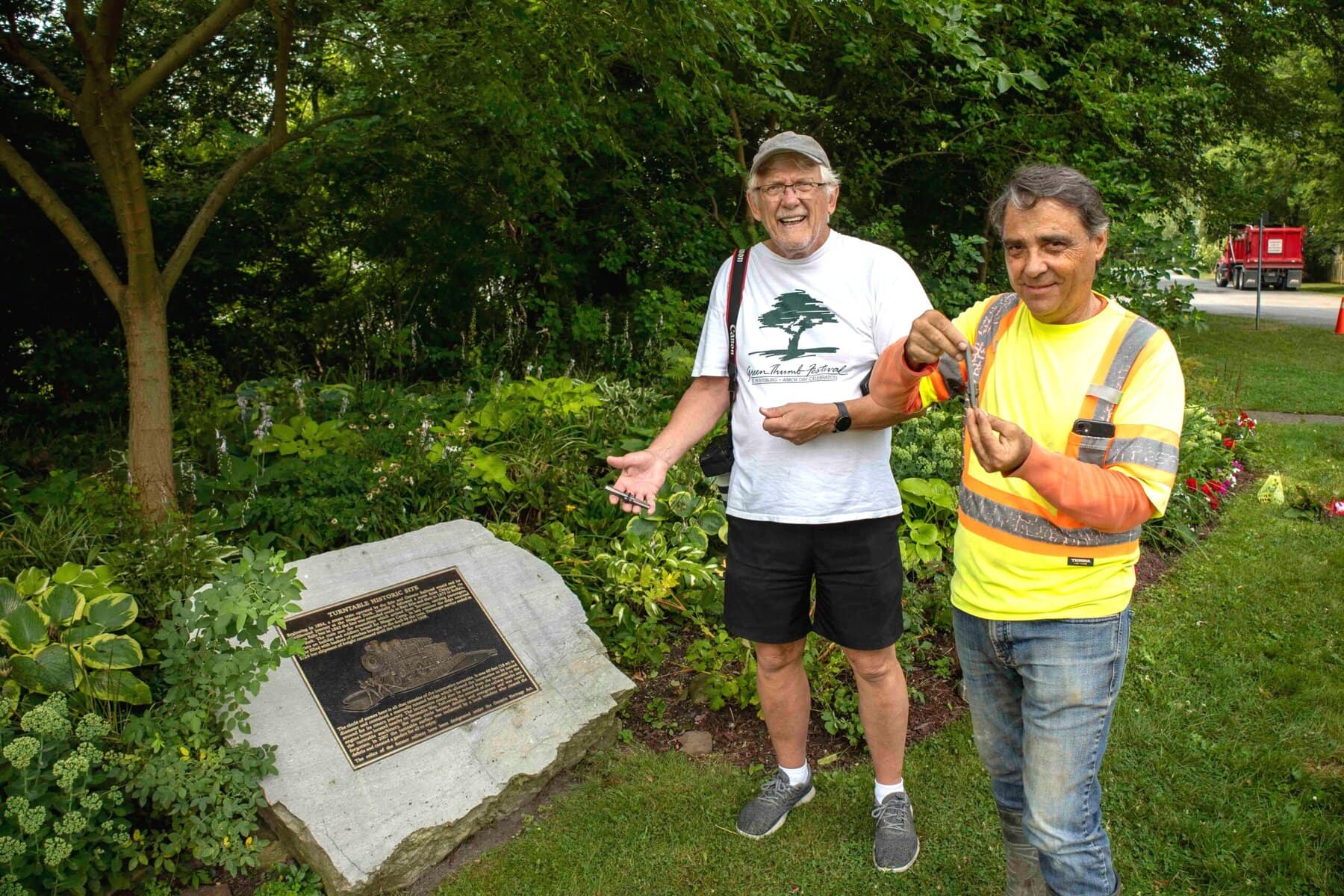 Ron Simkus, left, and Frank Racioppo hold a traditional “feathers and wedges” tool used to split stone by hand — the same 19th-century method being used to recreate missing pieces of the historic railway turntable.