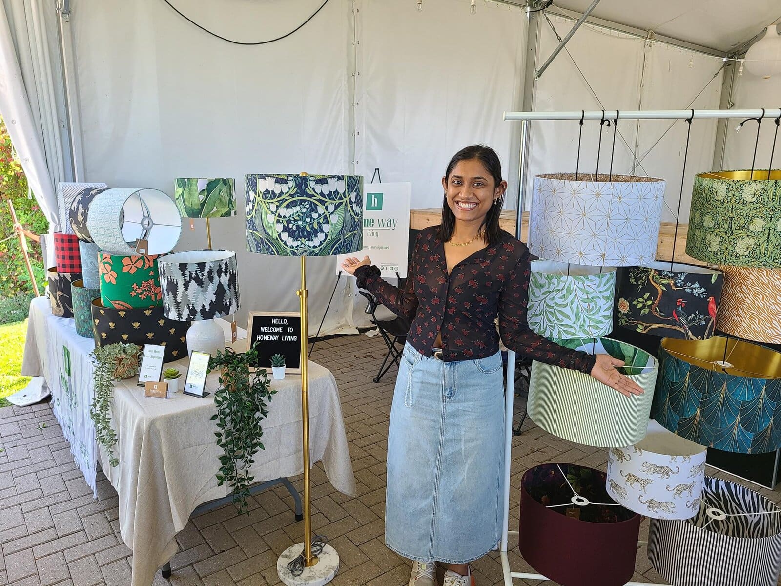 Mira Maniya of Homeway Living showcases her handcrafted lampshades, blending her background in architecture with interior design, at the Little Hearts Market. 