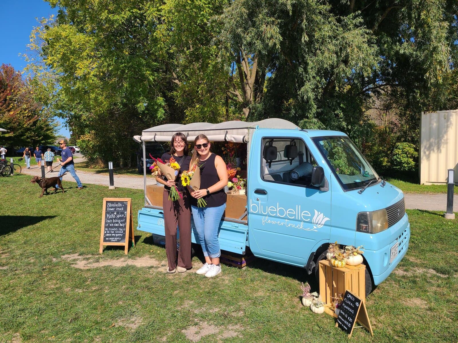 Shelley Benson (right) and daughter welcome customers at the Bluebelle Flower Truck, where visitors can build their own bouquets with locally grown blooms. 