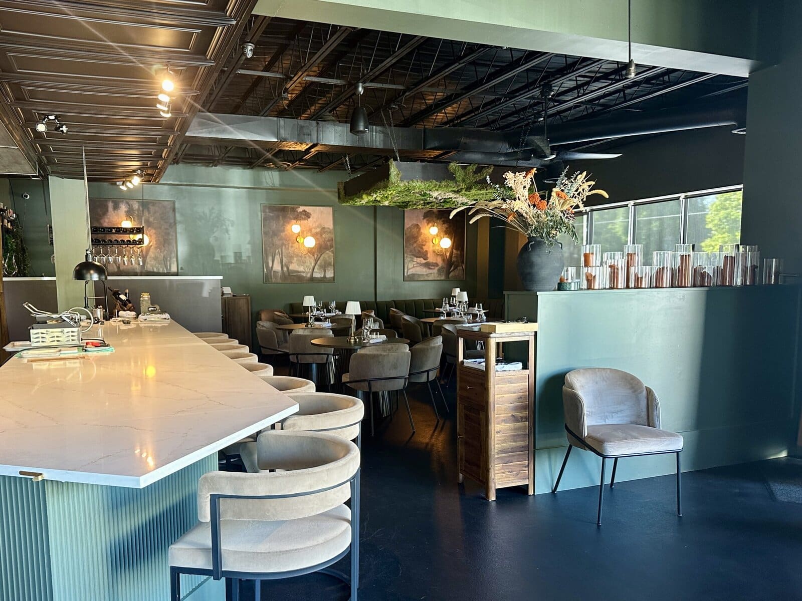 The fine-dining side of Revé features bar seating and a dining room designed around earth tones.