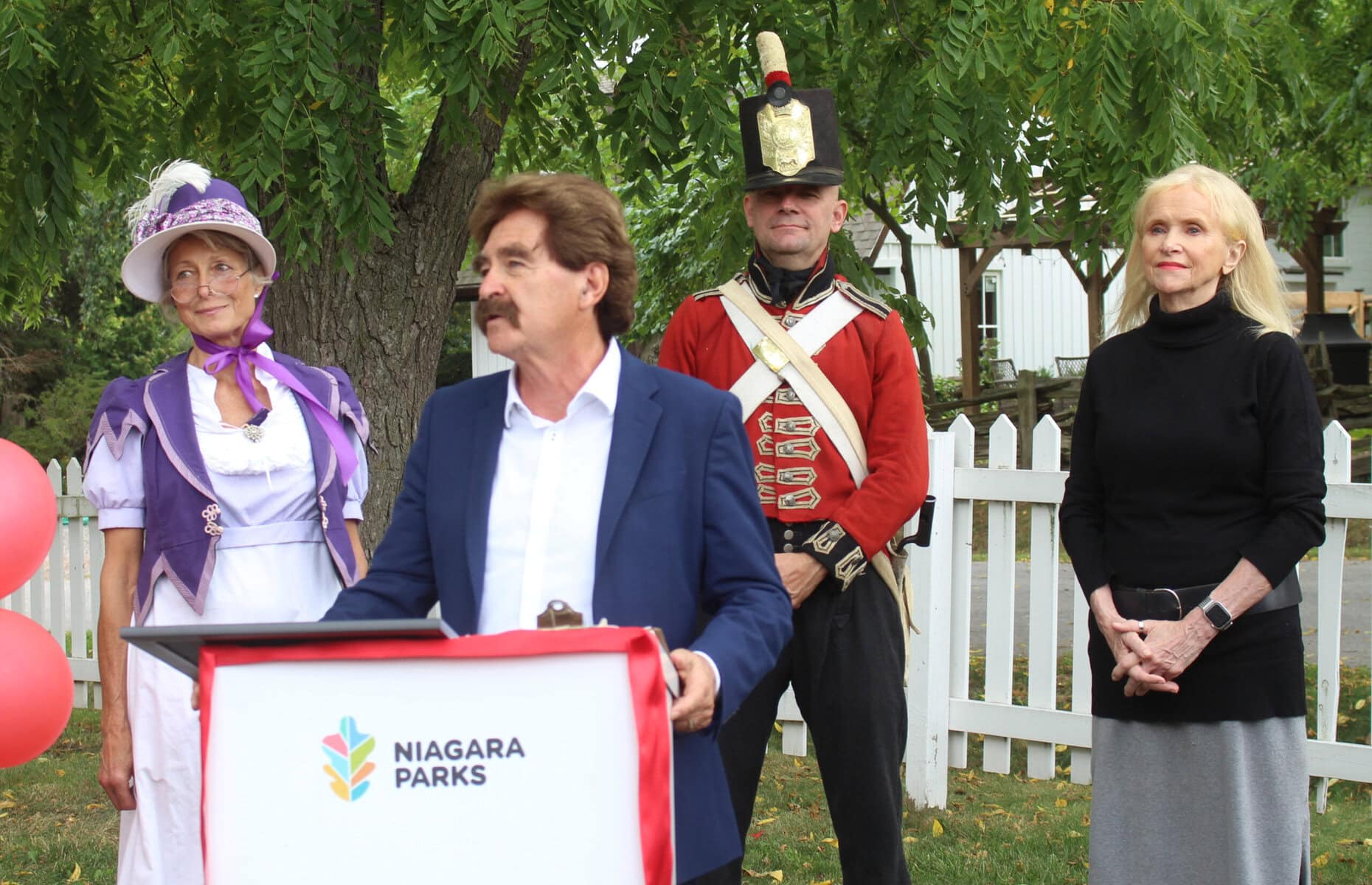 Wayne Gates (front) addresses crowd at Laura Secord's Homestead wishing her a happy birthday with Cathy Thomas, Jim Hill, and Caroline McCormick (back). 