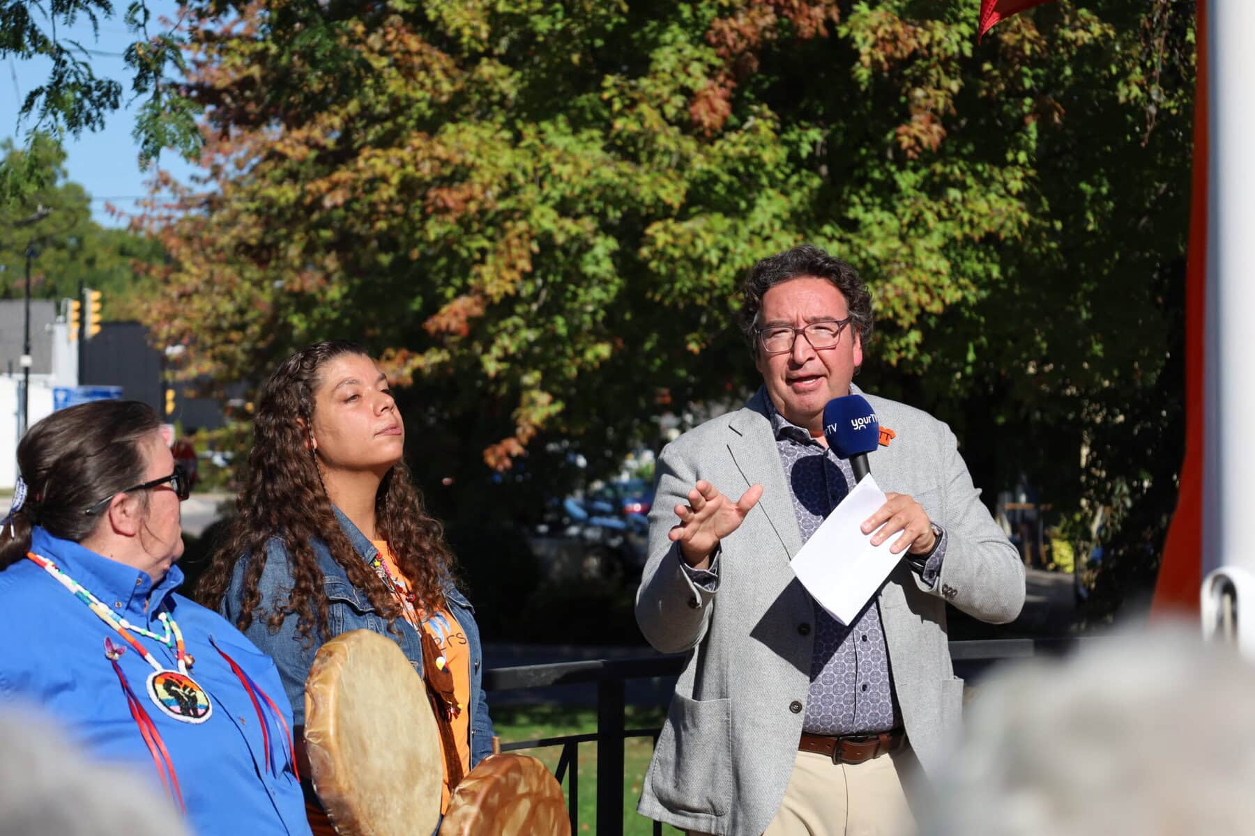 Lord Mayor Gary Zalepa speaks alongside singers Cara-anne Farrow-lawrence and Sandi Mansfield. Zalepa says the turnout at NOTL's ceremony was the best he's ever seen.