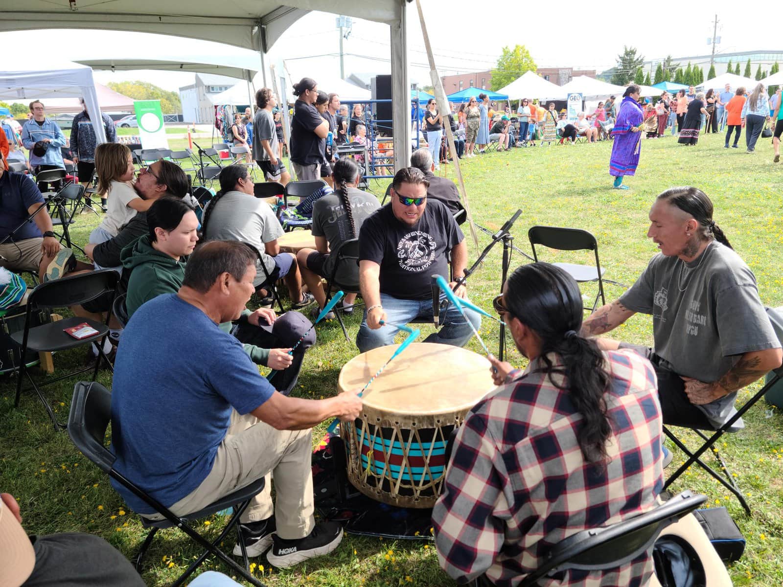 Drumming and chanting circle perform during the Nurturing Our Roots Traditional Powwow.