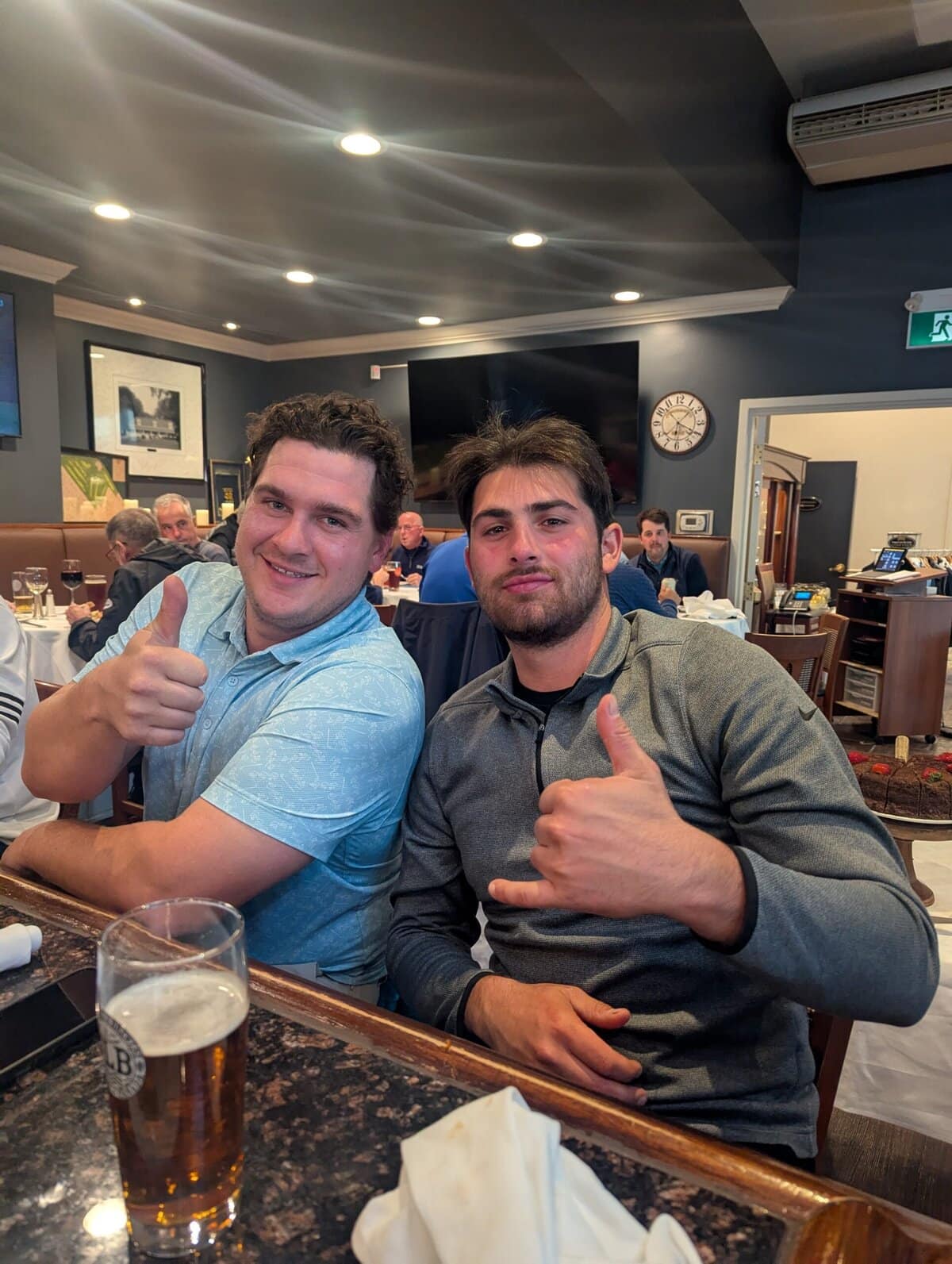 Derek Merza, left, gives a big thumb's up to long drive champions Nick Elia, right.